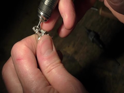 Jeweler is drilling a hole for setting a precious stone.