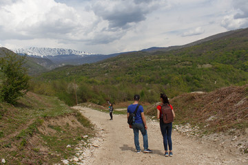 Travelers travel on the road in mountains go trekking Countryside, village - mountains, Clouds