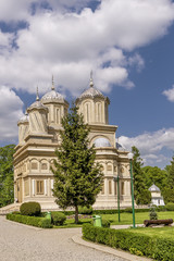 Fototapeta na wymiar Beautiful vertical view of the Curtea de Arges Monastery and Cathedral on a sunny day, Romania