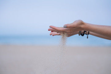 Hand holding down the sand