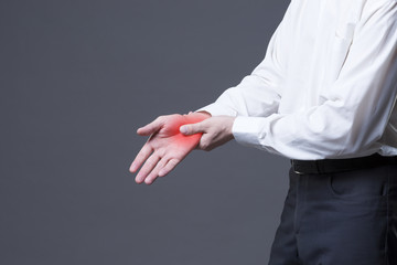 Pain in hand, joint inflammation, carpal tunnel syndrome on gray background