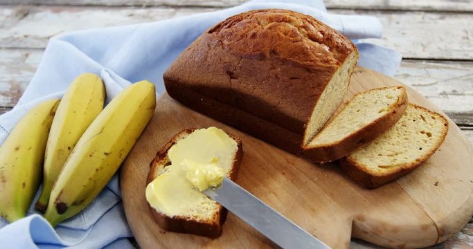 Butter spread on bread slice and bananas