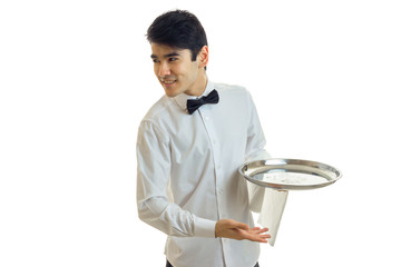 handsome young waiter's shirt smiling looks to the side and holding a tray