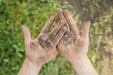 Dirty palms of the child. Dirty hands of a child in the ground. hygiene. Child cleanliness education