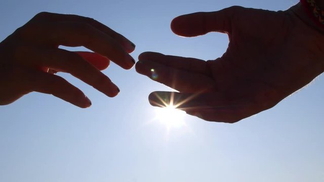 Hands of Man and Woman Parting Against Sky With Sun. Break Up. Close-Up. HD, 1920x1080.  