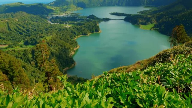Establishing shot of the Lagoa das Sete Cidades lake taken from Vista do Rei in the island of Sao Miguel, The Azores, Portugal. The Azores are one of the hidden gem destinations in Europe.