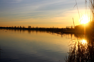 Evening sunset. Bridge and lake. Sun rays in the evening. Ukraine. A fascinating sunset.