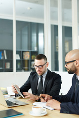 Confident traders reading online data in office