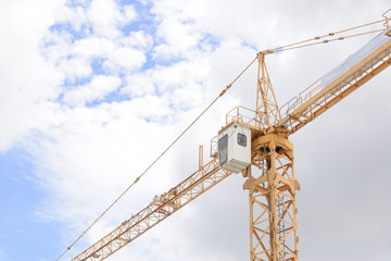 The arm of construction crane with the blue sky.Heavy construction concept.