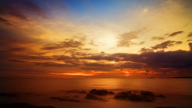 Sunrise over the ocean with fast moving clouds. Timelapse FullHD 1080p.