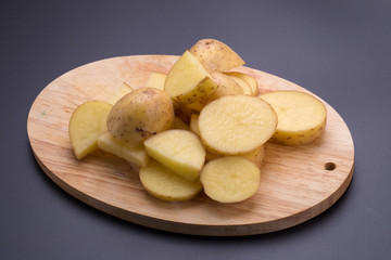 Potatoes and potato sliced on a black background