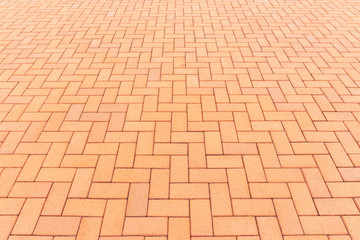 Paver brick floor also call brick paving, paving stone or block paving. Manufactured from concrete or stone for road, path, driveway and patio. Empty floor in perspective view for texture background.