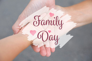 Family hands on gray background