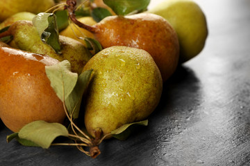 Heap of fresh pears on grey table closeup