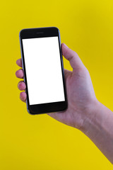 hold smartphone on background yellow