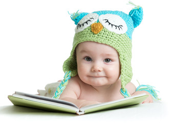 baby infant in funny owl knitted hat owl with book on white background