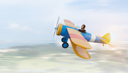 Woman in retro airplane . Mixed media