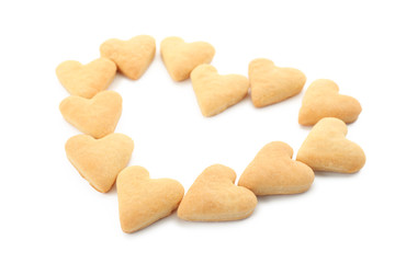 Heart shape made of butter cookies on white background