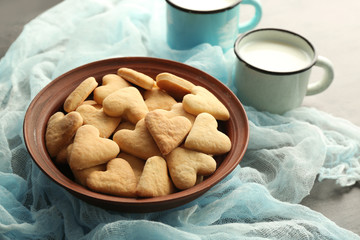 Plate with heart shaped butter cookies on table