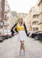 Beautiful young women posing in different clothes in urban surroundings