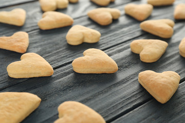 Heart shaped butter cookies on wooden background