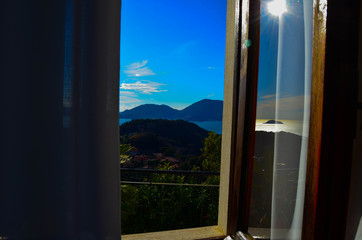 .View from the window at the sea and mountains Italy