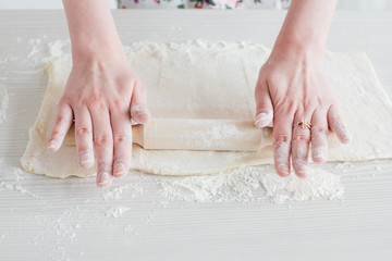 Young beautiful woman preparing homemade croissants