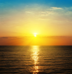 Obraz premium orange sunset and dark sea