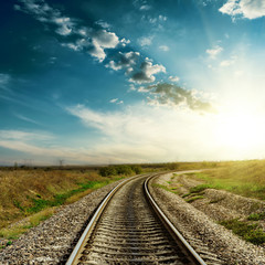 Fototapeta na wymiar sunset in blue sky over railroad