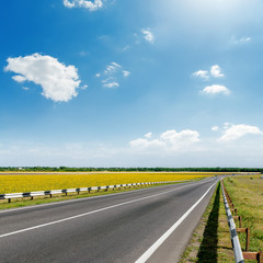 asphalt road and blue sky with clouds