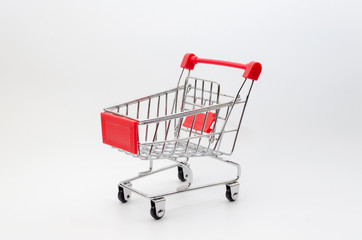 mini supermarket shopping cart on white background, holiday sale and shopping concept, selective...