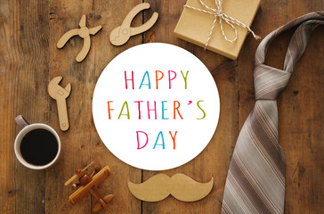 top view composition with wooden shape tools, necktie, cup of coffee. Father's day concept