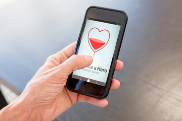 Composite image of become a hero text with heart shape on screen