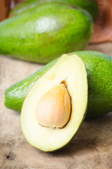 Half of avocado fruit on wooden background,Healthy food