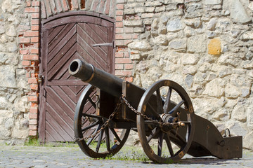 Ancient cannon in old castle in sunny summer day