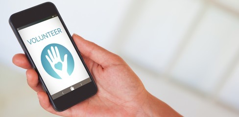 Composite image of womans hand holding black smartphone