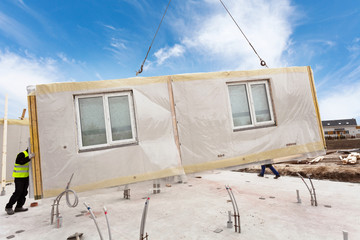 Roofer builder workers with crane installing structural Insulated Panels SIP. Building new frame energy-efficient house