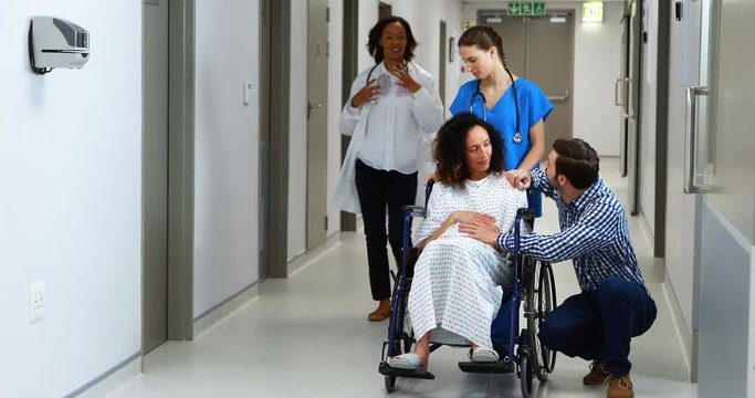Doctors rushing pregnant woman to the emergency room