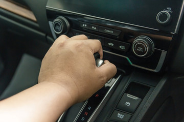 hand on automatic gear shift, Man hand shifting an automatic car, luxury car design interior