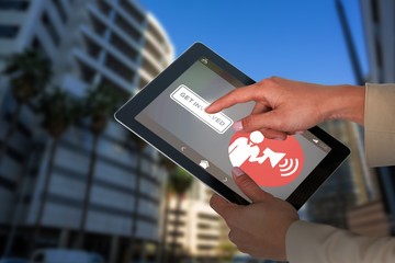 Composite image of businesswoman using digital tablet