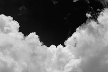Isolated clouds over black.