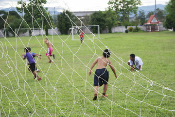 Chaingrai, Thailand 09/06/2017, Street childrens play ball on lawn in a break time.