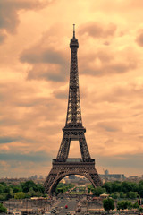 Fototapeta na wymiar Eiffel Tower in Paris at sunset with cumulus clouds. Tour Eiffel at sunset. 