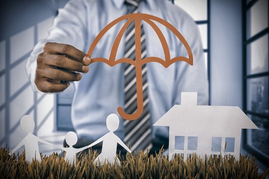 Composite image of insurer protecting family by a red umbrella