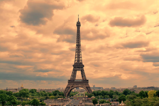 Eiffel Tower in Paris at sunset with cumulus clouds. Tour Eiffel at sunset. 