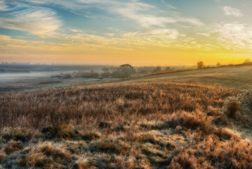 Fototapeta na wymiar Autumn morning. Foggy dawn in a picturesque field