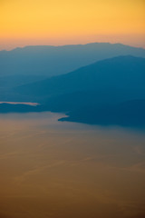 Orange sunset in the mountains. View from a height.