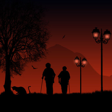 Elderly people on red night taking a walk in a park