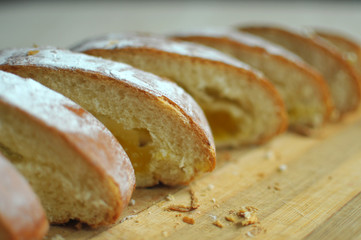 Cut pineapple pie with slices on a cutting board