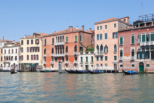 Grand Canal Venice, Veneto, Italy. The traghetto at San Toma, San Polo, crossing  in front of historic palazzos with locals and tourists
